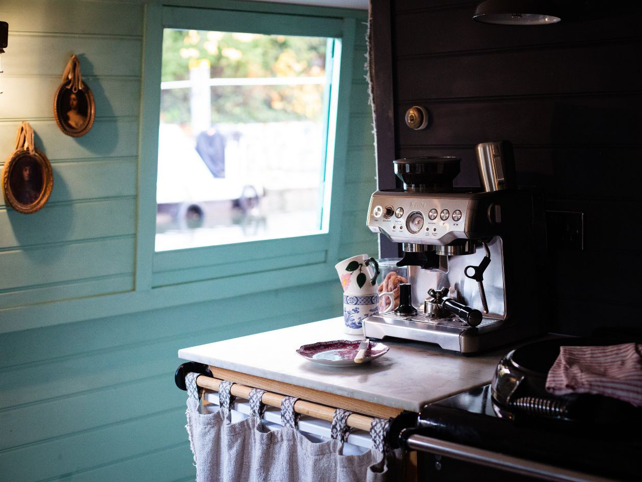 Small kitchen corner with a table, chairs, and window letting in daylight